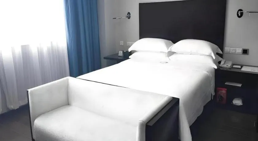 Bed in Guangdong Nanmei Osotto Hotel