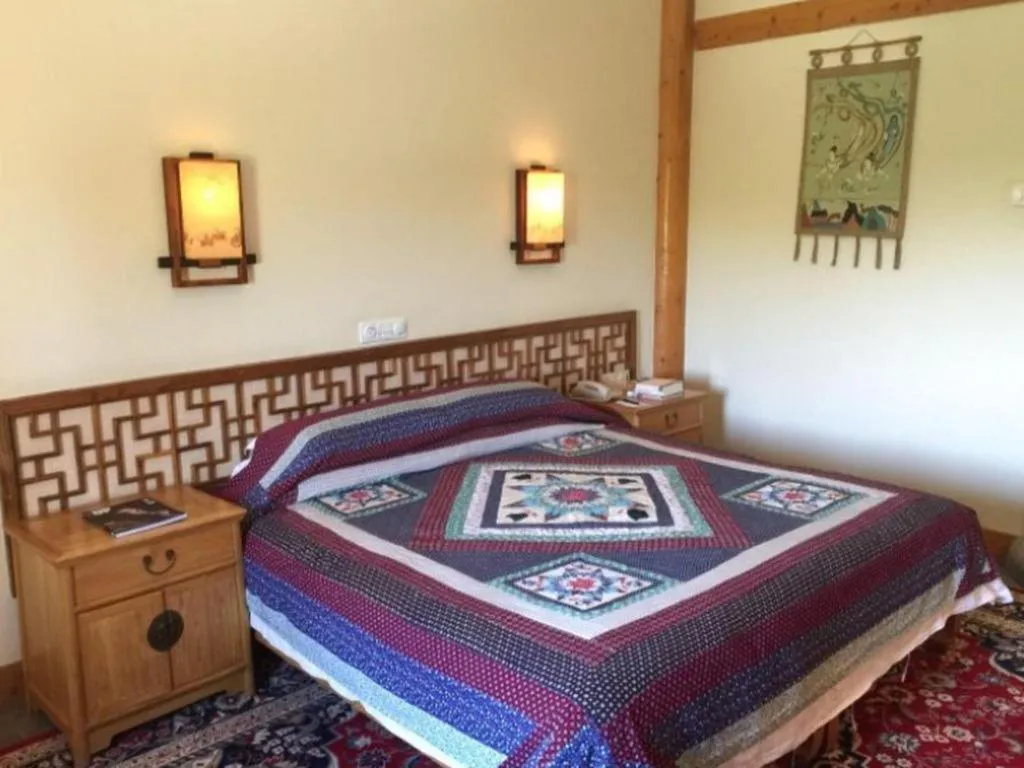 Bed in The Silk Road Dunhuang Hotel