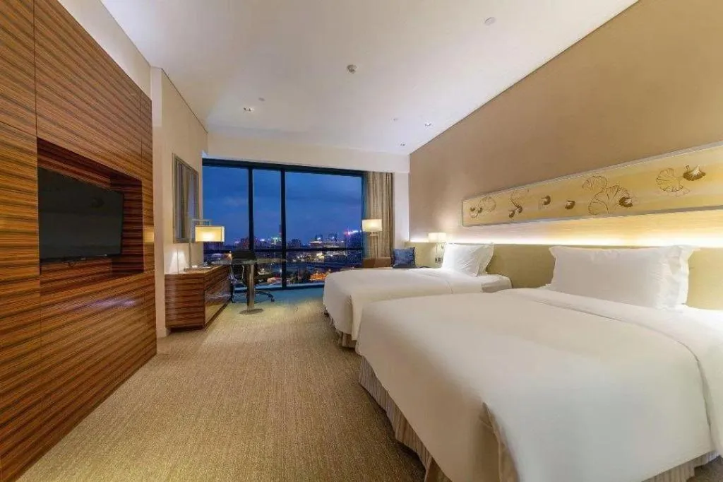 Bed in New World Guiyang Hotel