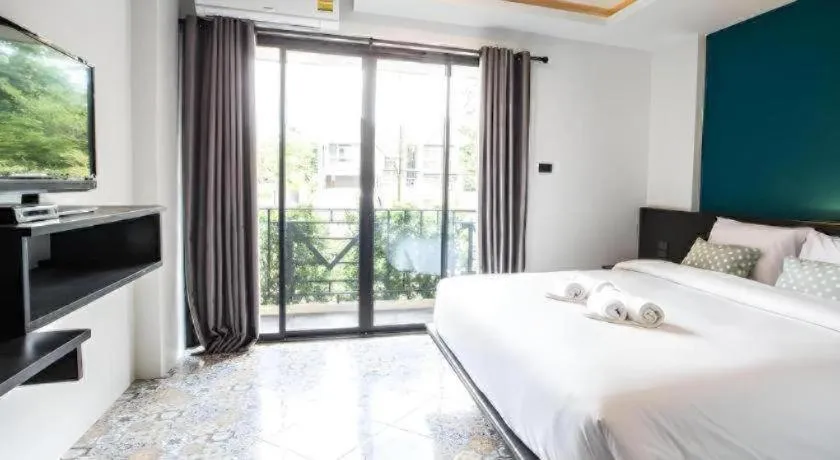 Bed in M Boutique Resort