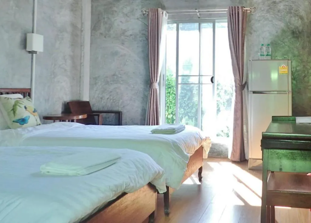 Bed in Rommai Rimnaam Resort