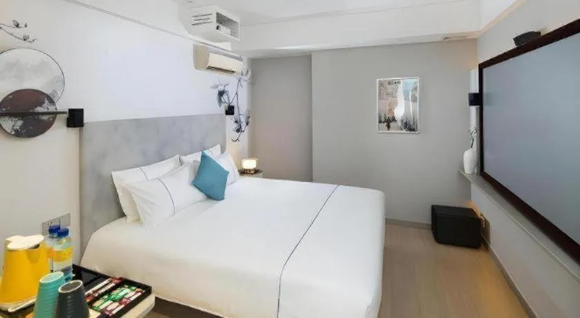 Bed in Magnotel Hotel Shanghai Jinjiang Park Branch