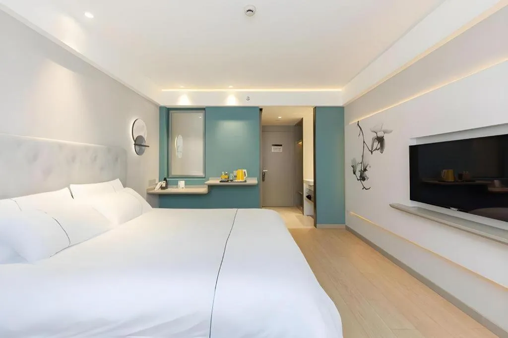 Bed in Magnotel Hotel Shanghai Jinjiang Park Branch