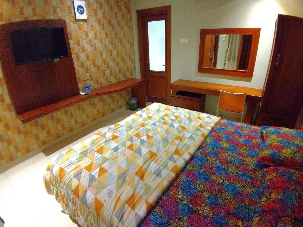 Bed in Hotel Adilla Syariah Ambarukmo