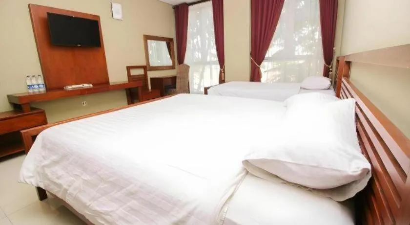 Bed in Hotel Adilla Syariah Ambarukmo