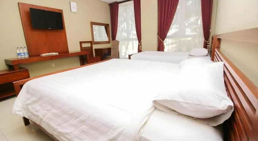 Bed in Hotel Adilla Syariah Ambarukmo