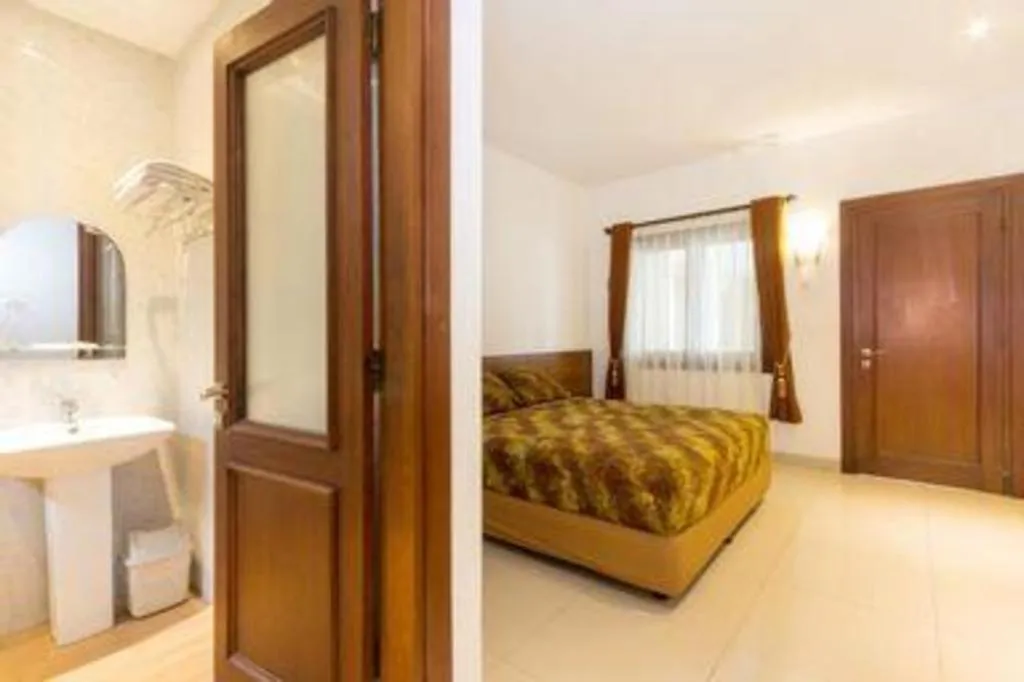 Bed in Hotel Adilla Syariah Ambarukmo