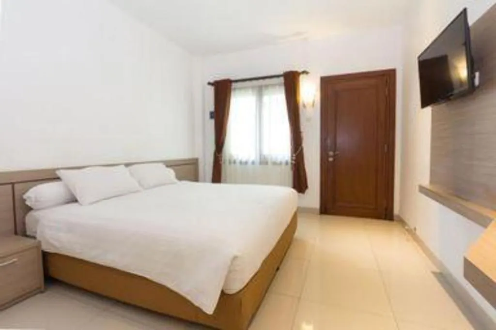 Bed in Hotel Adilla Syariah Ambarukmo