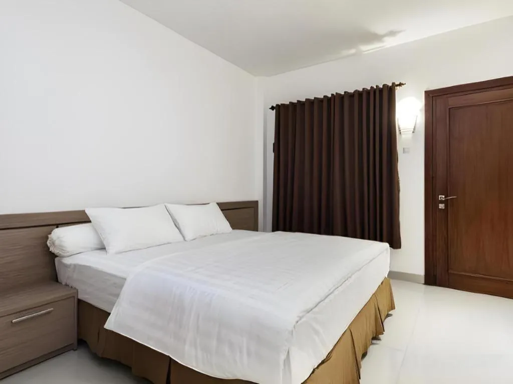 Bed in Hotel Adilla Syariah Ambarukmo