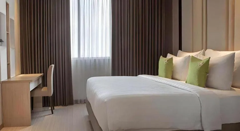 Bed in Hotel Dafam Pacific Caesar