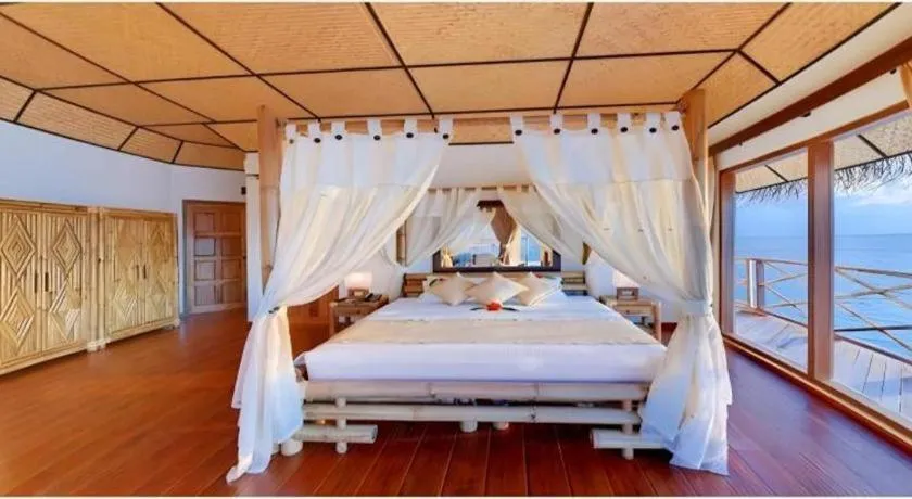 Bed in Angaga Island Resort and Spa