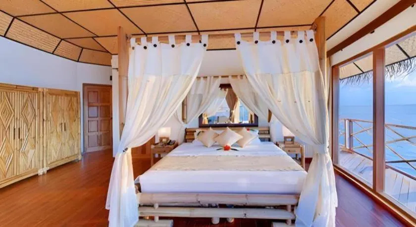 Bed in Angaga Island Resort and Spa