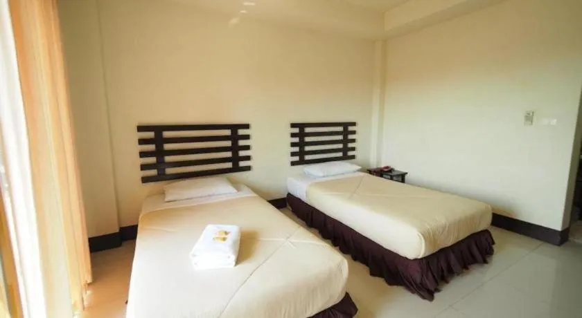 Bed in AmornSukhothai Hotel