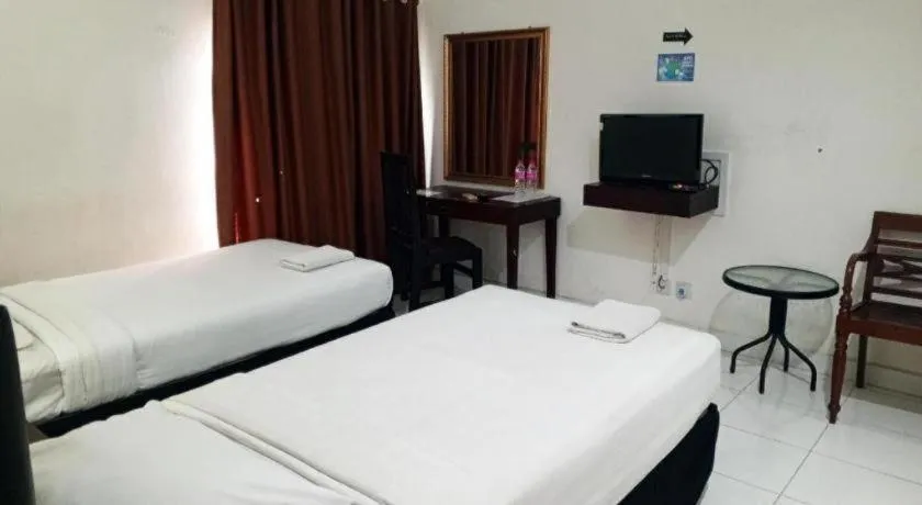 Bed in The Garden Hotel