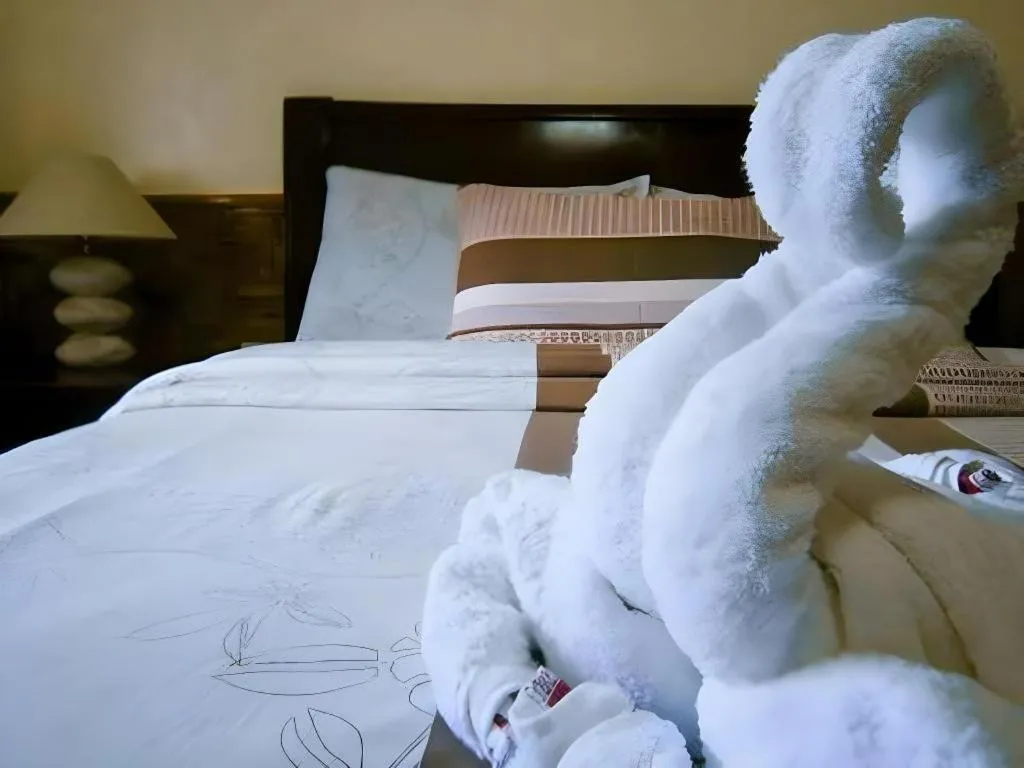 Bed in Coucou Bar Hotel and Restaurant