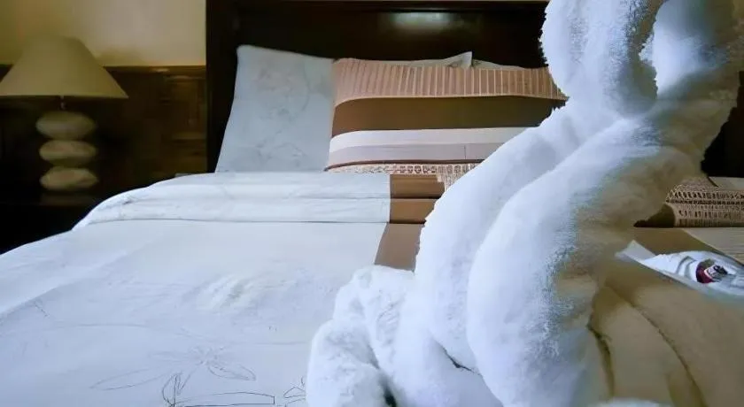 Bed in Coucou Bar Hotel and Restaurant