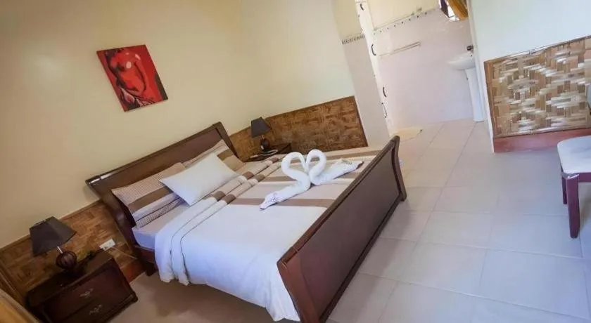 Bed in Coucou Bar Hotel and Restaurant