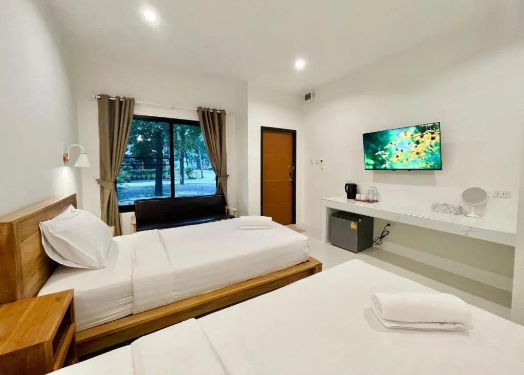 Bed in Baan Klang Suan Resort