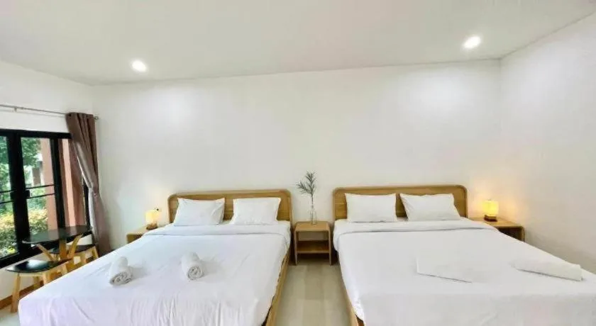 Bed in Baan Klang Suan Resort
