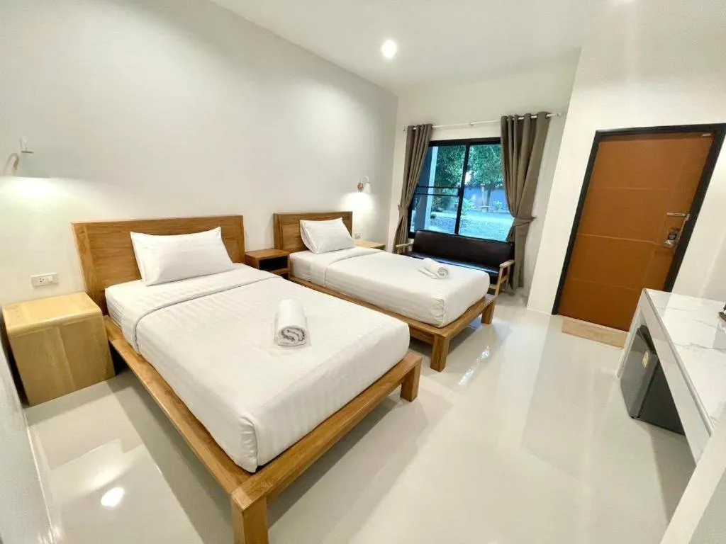 Bed in Baan Klang Suan Resort