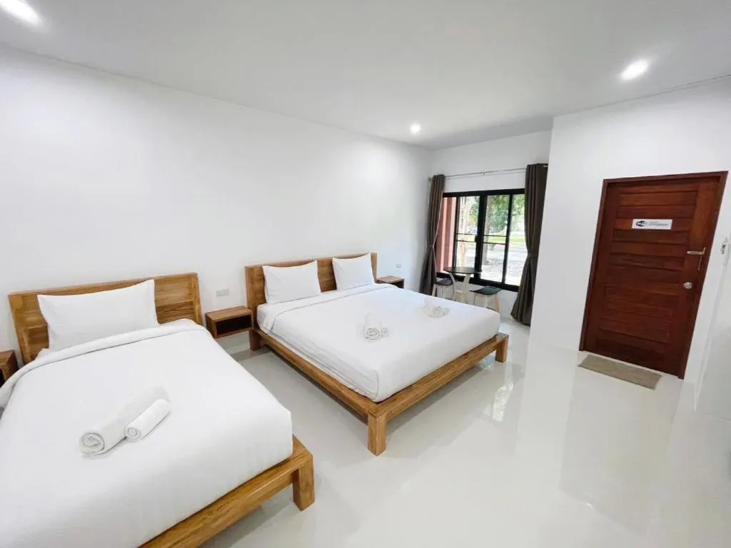 Bed in Baan Klang Suan Resort