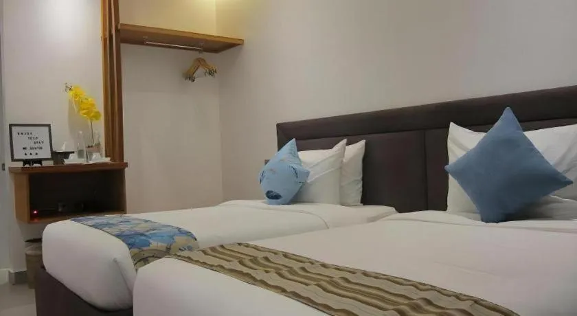 Bed in White Breeze Palawan Boutique Hotel