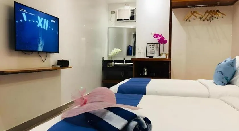 Bed in White Breeze Palawan Boutique Hotel