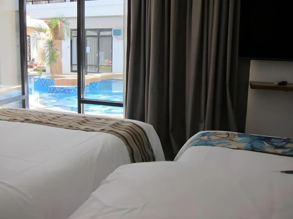 Bed in White Breeze Palawan Boutique Hotel