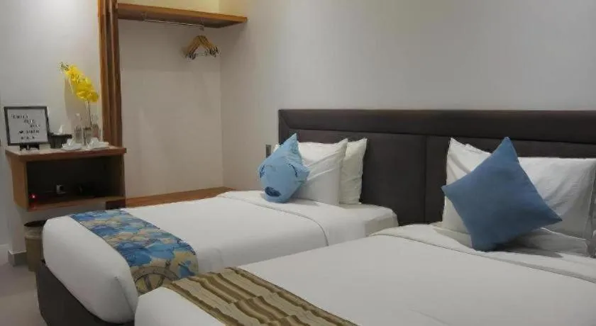 Bed in White Breeze Palawan Boutique Hotel