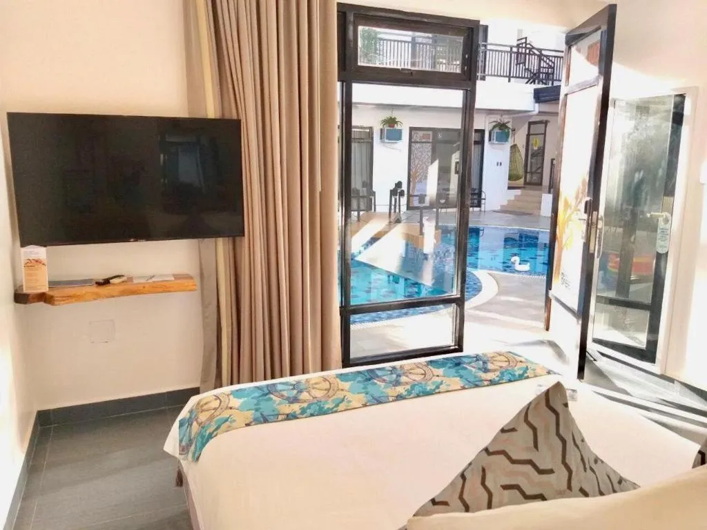 Bed in White Breeze Palawan Boutique Hotel