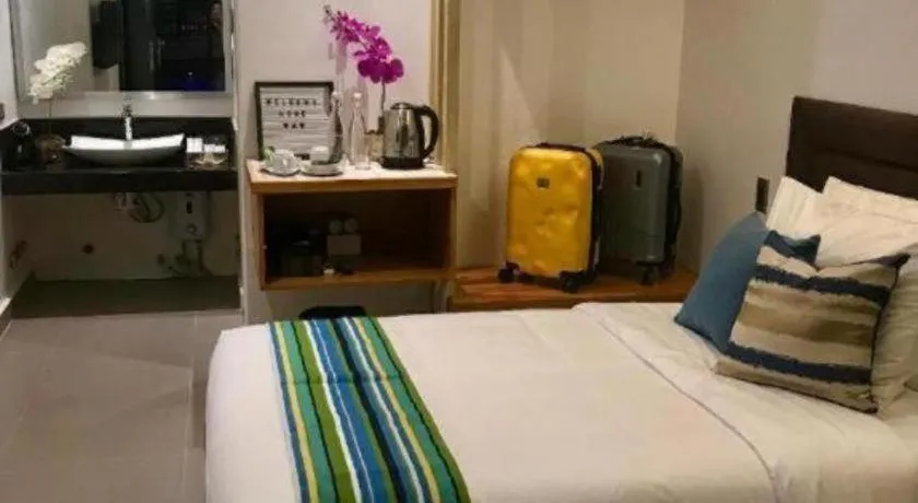 Bed in White Breeze Palawan Boutique Hotel