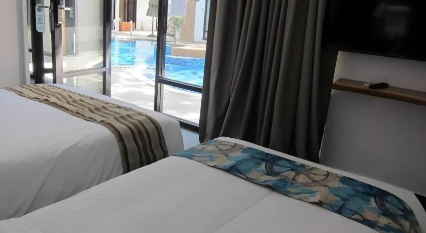 Bed in White Breeze Palawan Boutique Hotel