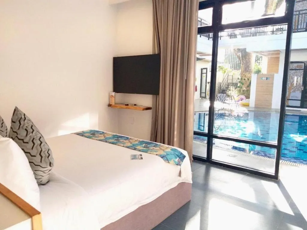 Bed in White Breeze Palawan Boutique Hotel