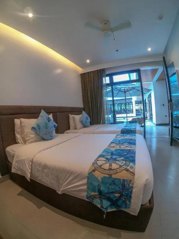 Bed in White Breeze Palawan Boutique Hotel