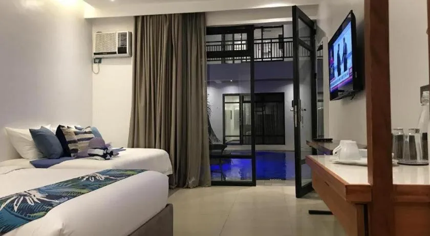 Bed in White Breeze Palawan Boutique Hotel