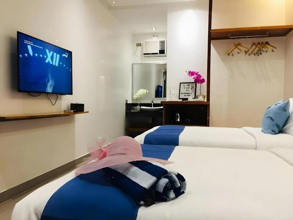 Bed in White Breeze Palawan Boutique Hotel