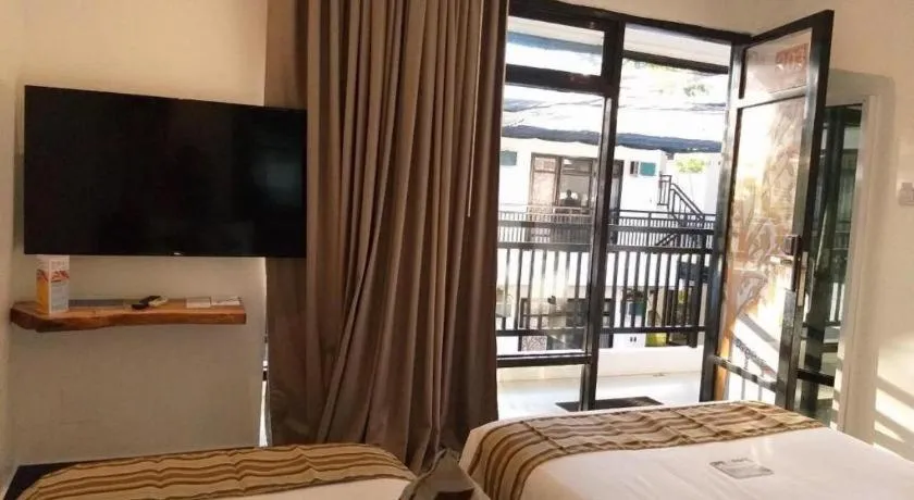 Bed in White Breeze Palawan Boutique Hotel