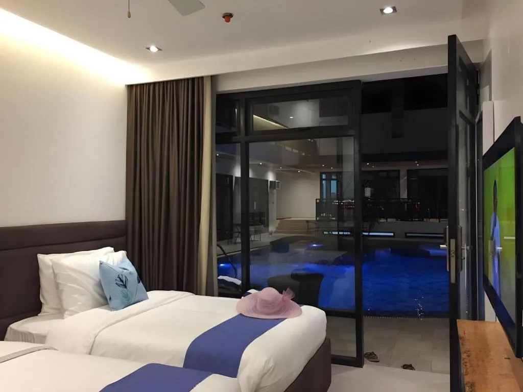 Bed in White Breeze Palawan Boutique Hotel