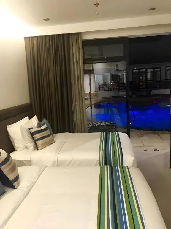 Bed in White Breeze Palawan Boutique Hotel