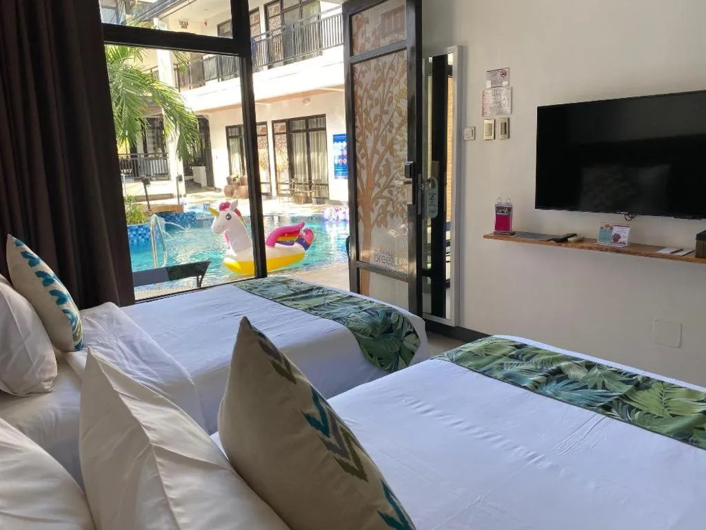 Bed in White Breeze Palawan Boutique Hotel