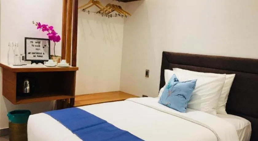 Bed in White Breeze Palawan Boutique Hotel