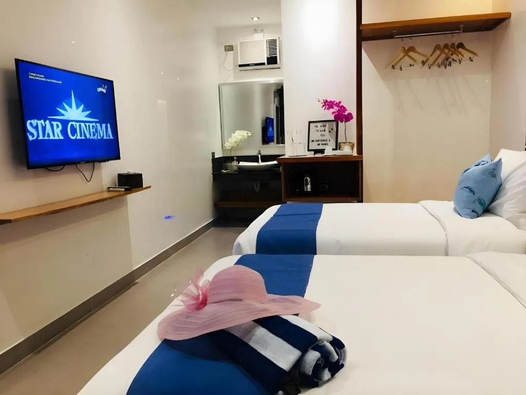 Bed in White Breeze Palawan Boutique Hotel