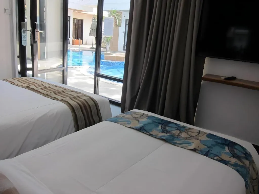 Bed in White Breeze Palawan Boutique Hotel