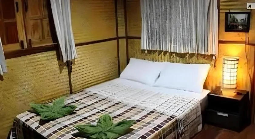 Bed in Green Cottage Beach Resort
