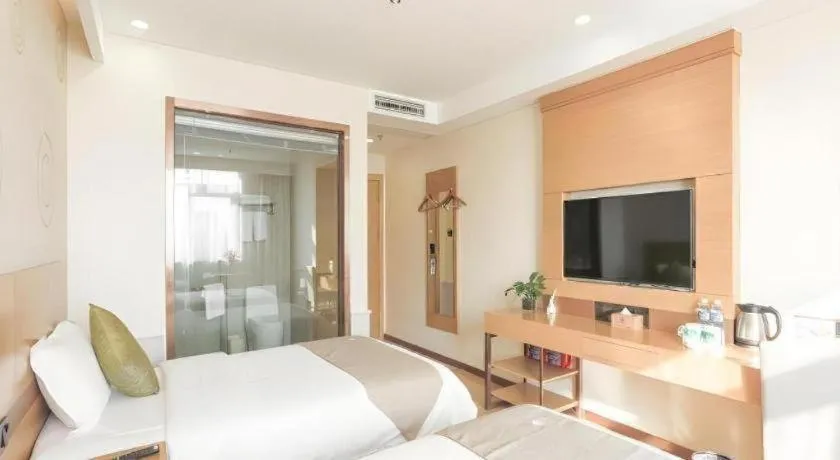 Bed in GreenTree Inn Zhangjiagang Yangshe Old Street Stadium