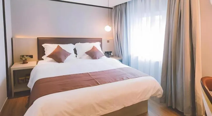 Bed in GYA Shanghai Jiangpu Hotel