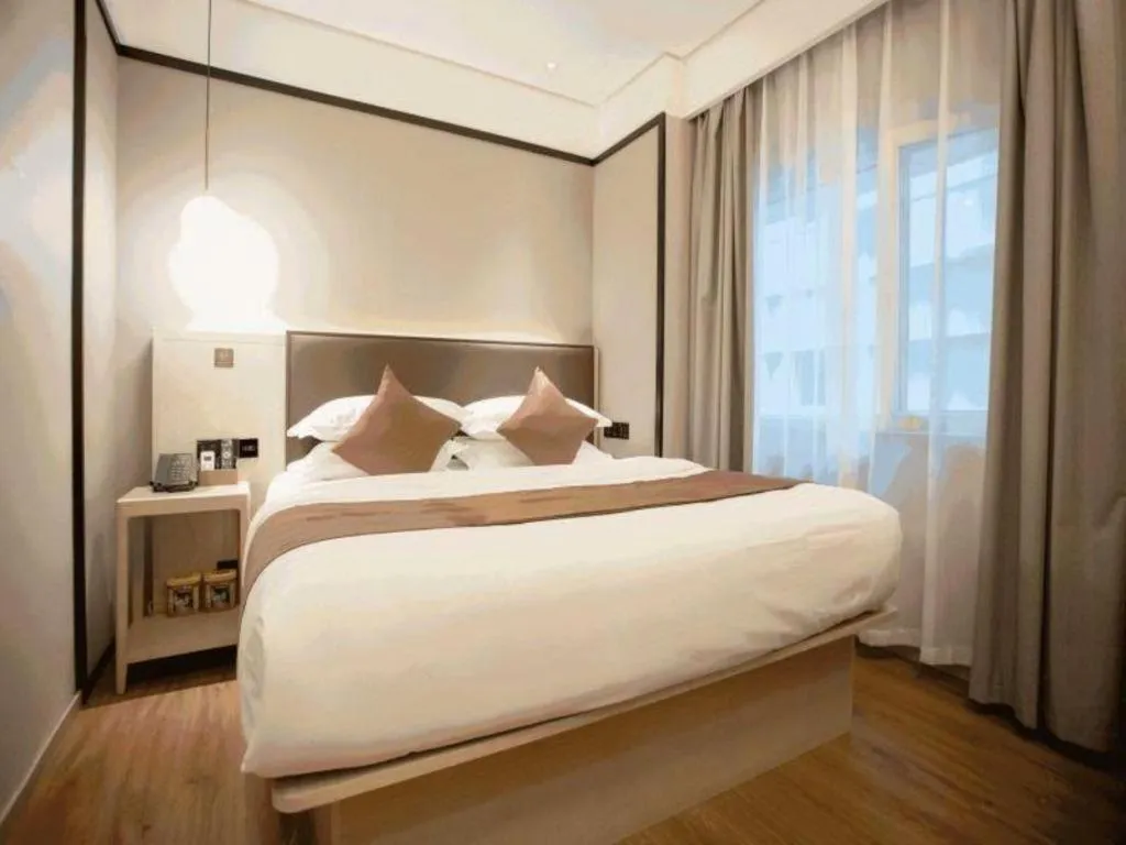 Bed in GYA Shanghai Jiangpu Hotel