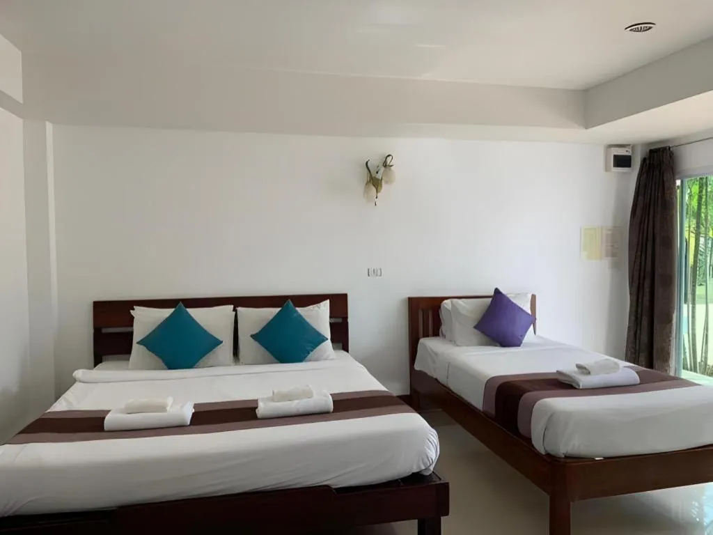 Bed in Rattana Pura Beach Resort