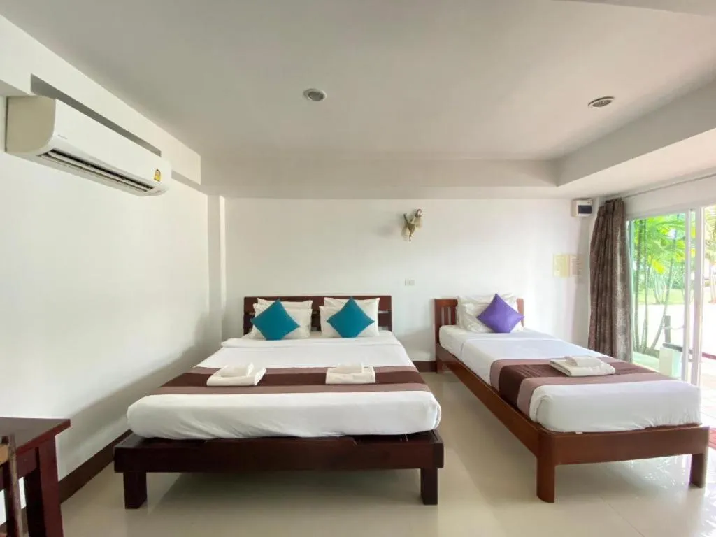 Bed in Rattana Pura Beach Resort