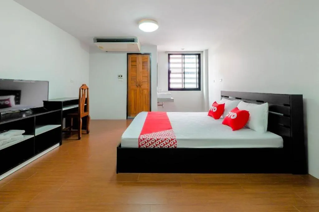 Bed in OYO 935 The Palm Apartment